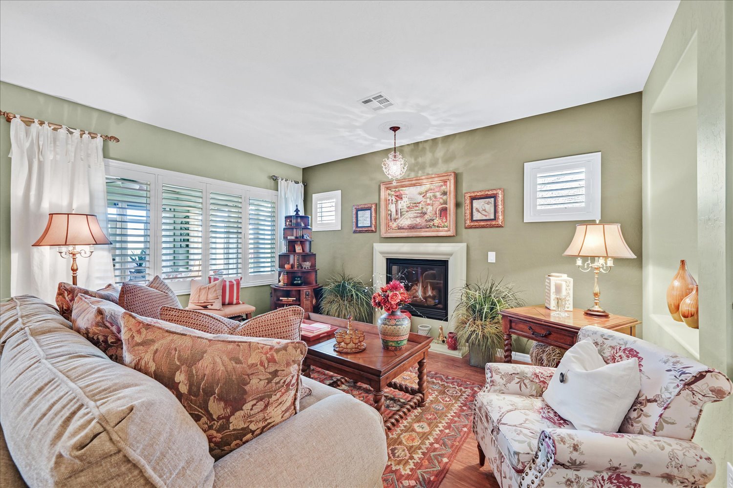 Front exterior of Las Vegas home with desert landscaping and mature tree