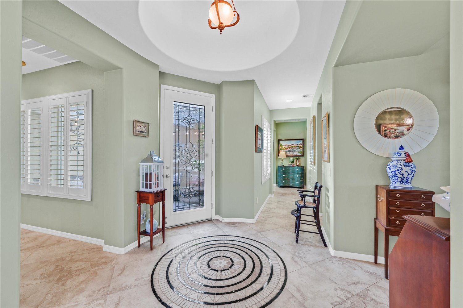 Alternate view of formal living area with built-ins and layered rugs