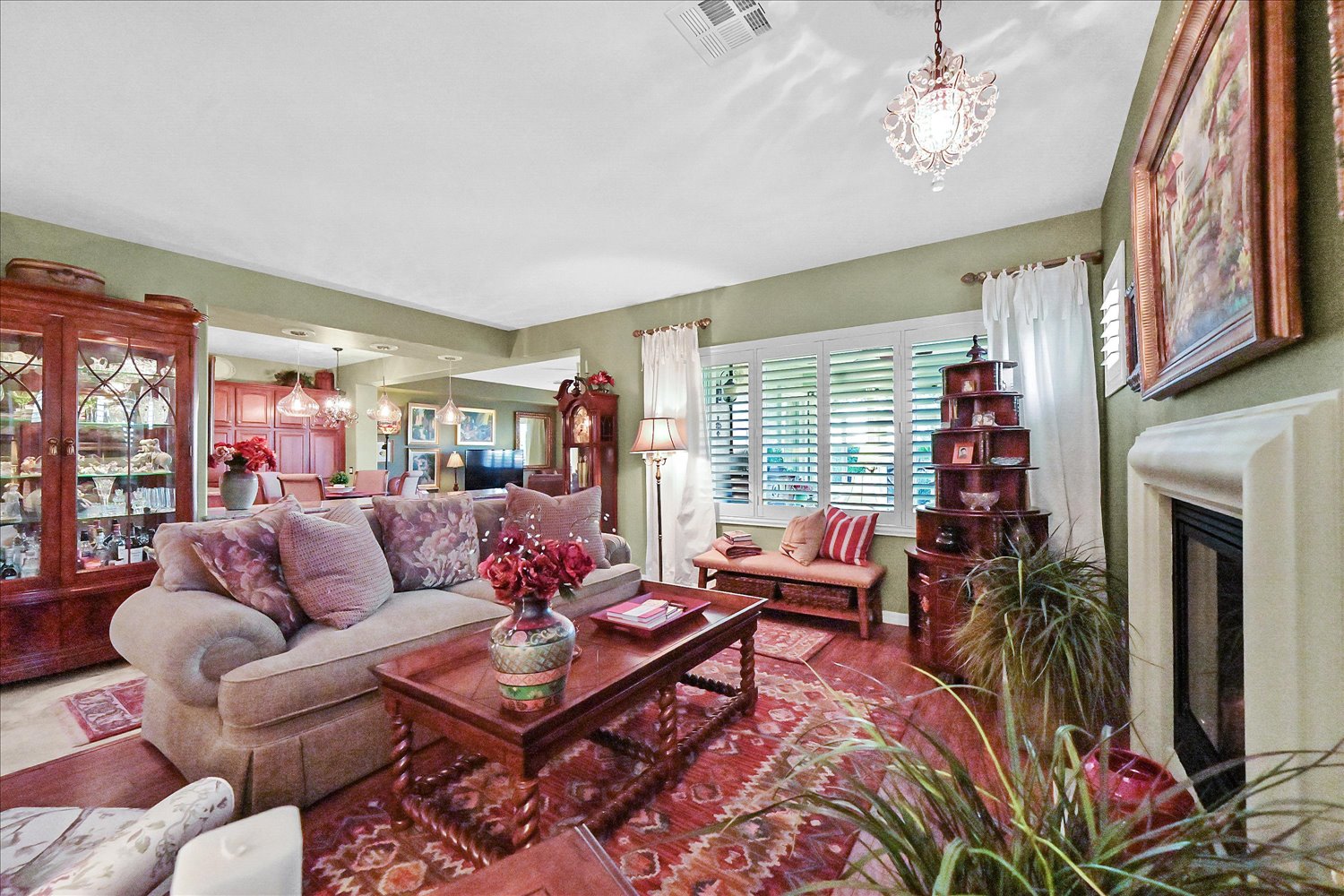 Guest bedroom with chandelier and neutral decor